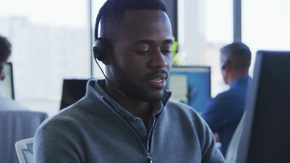 Young man with headset working on computer