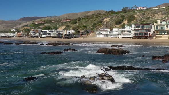 Beautiful beachfront homes on famous Malibu Beach near Los Angeles, California, USA. Panning shot ov