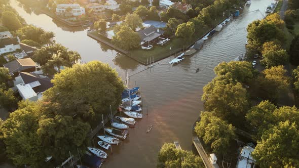 Aerial parallax shot of canals in San Isidro city, Greater Buenos Aires at golden hour