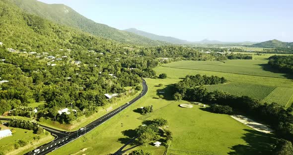 Aerial view of motorway going through the hills and grassland.