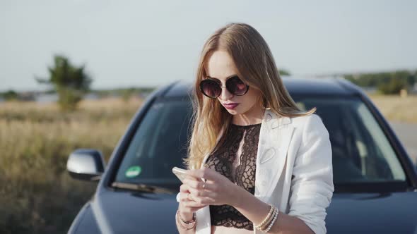 Nervous Lady Typing on the Phone at Breakage Car Out of City