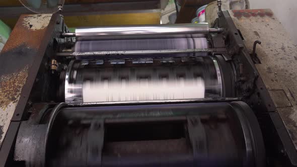 Books are being printed through machines.