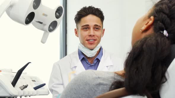 Handsome Male Dentist Working with His Patient