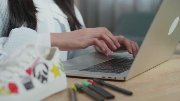 Close Up Of Female Footwear Designer'S Hands Typing On A Laptop At Home