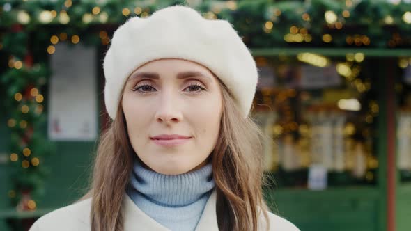 Handheld video shows of beautiful woman in winter clothes. Shot with RED helium camera in 8K