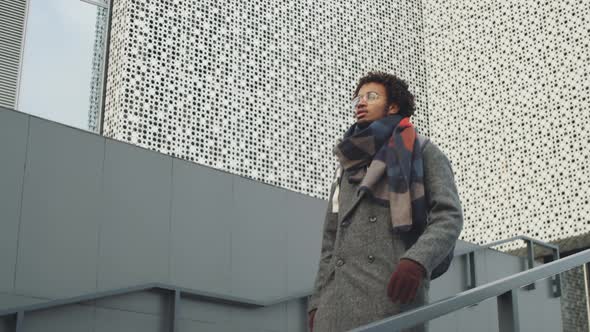 Young Black Man Walking Downstairs in City