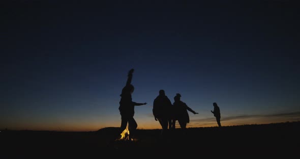 Silhouettes of People Having Fun at Campfire