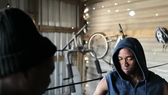 Coach tying hand wrap to a Boxer in the gym