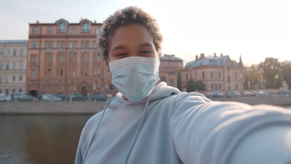 Young African Woman Wearing Protective Face Mask Taking Selfie Photo Outdoors