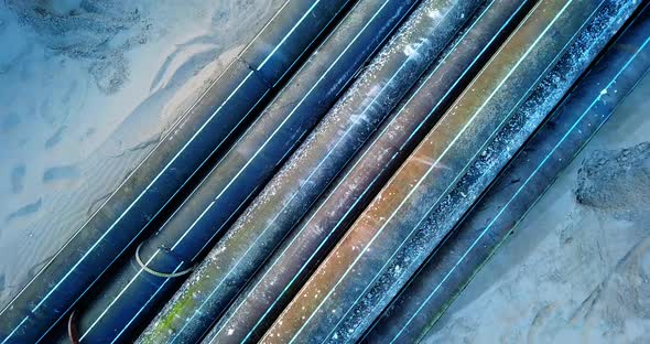 Old Color Plastic Drainage Pipes Lie on Sand Sea Beach alt