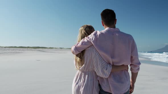 Couple in love enjoying free time on the beach together