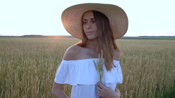 Amazing Portrait of Beautiful Woman Standing in Field of Ripe Golden Wheat