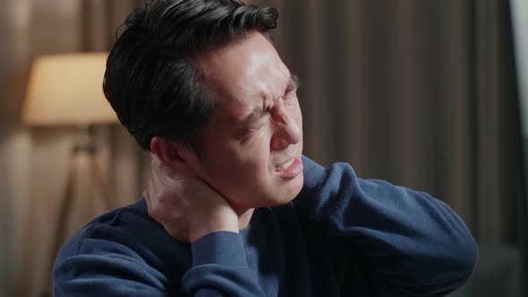 Asian Male Engineer With The House Model Having A Neck ache While Working On A Desktop At Home