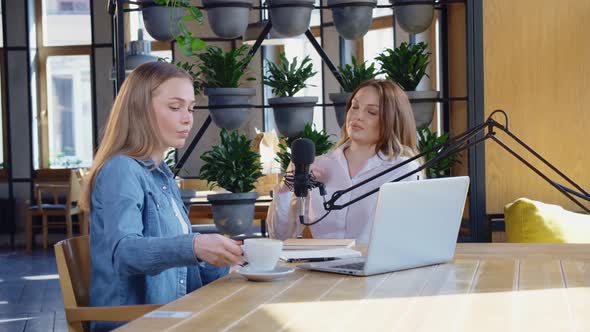 Charming Women Communicating with Tasty Coffee in Cafe