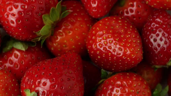 Juicy ripe exotic strawberry rotates on a white background 360. Eco fruits and berries summer.