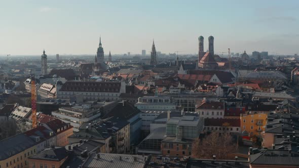 Sideways Flight Above Big German City Munich in Beautiful Daylight with Rooftops and Cathedrals
