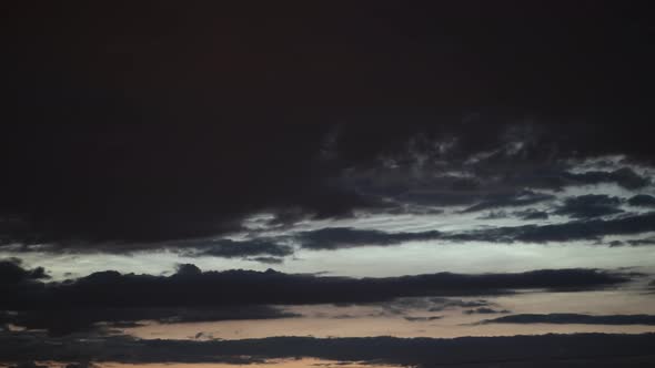 Noctilucent Clouds Hidden By Dark Low Clouds Drifting in Opposite Direction