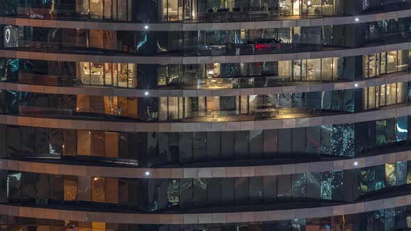 Outside View of Windows in Apartments of a High Class Building at Night Timelapse