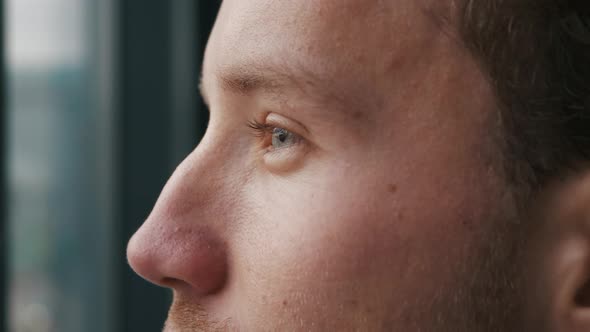 Close-up Portrait of a young man looking into the distance.