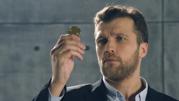 Portrait of Man Holding Bitcoin in His Hand and throw it out