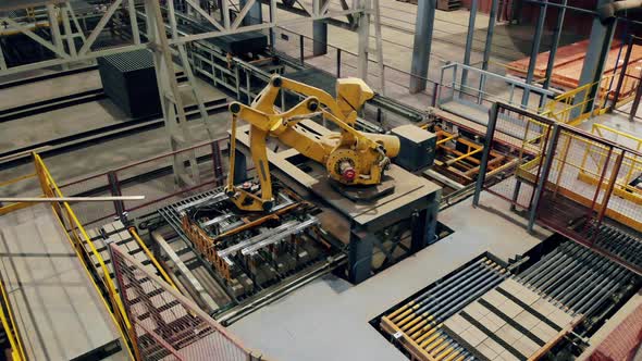 Modern Automated Factory Equipment. Robotic Loader Is Transporting Brick Products