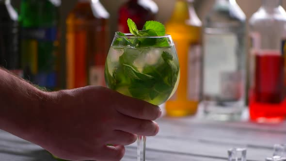 Man's Hand Taking Cocktail Glass.