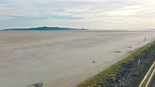 AERIAL - Railroad tracks and plains, Great Salt Lake, Utah, reverse shot