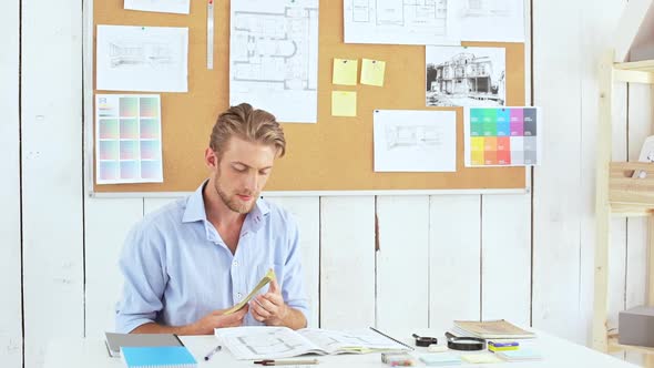 Successful Architector Holding Money Sitting at Workplace Slow Motion