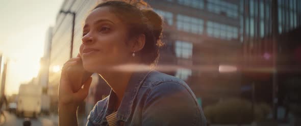 Handheld video of woman talking on the phone outdoors. Shot with RED helium camera in 8K.