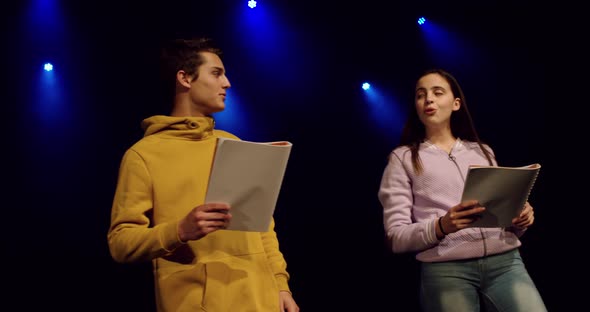 Teenagers rehearsing in a theatre alt