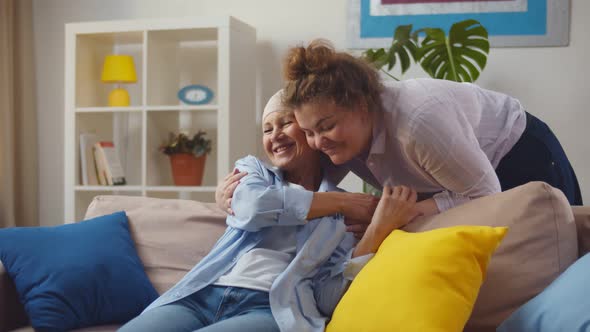 Young Woman Visiting Her Mother with Cancer Indoors