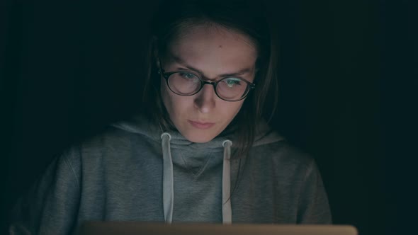 Brunette Girl Working on Notebook in the Night at Home