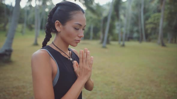 Asian Woman Meditating in the Jungle