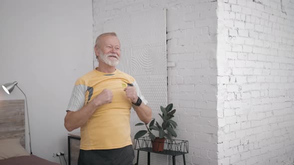 Happy Grandfather Athlete Leads an Active and Healthy Lifestyle Doing Useful Exercises To Maintain