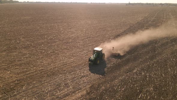 Slow Motion Drone View of Tractor Plowing Farm Field