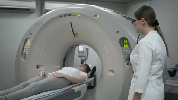 Female Patient On The Ct Or Mri Scanner Machine During X-Ray Process