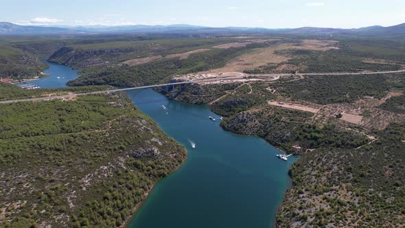 Flying over Krka river, autostrada and arch bridge at summer in Croatia, Europe