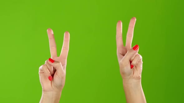Two Hands Show a Gesture of Peace. Green Screen Studio