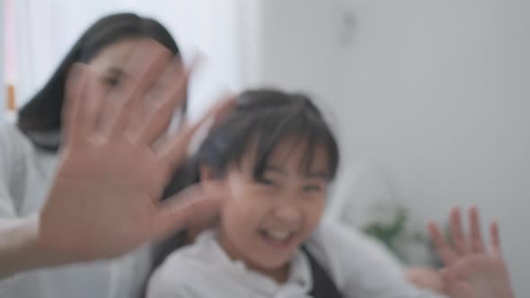 Close up mother hands open view of camera then play with kid and say hello in bedroom