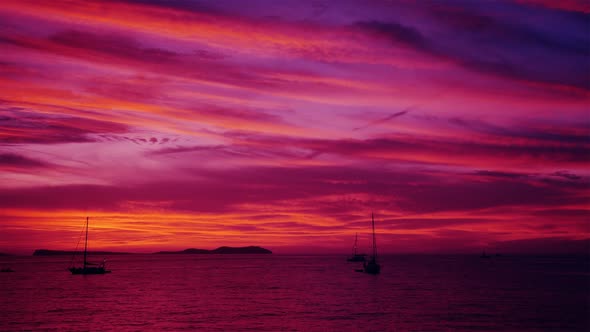 After Sunset Pink Afterglow With Sailing Ships And Yachts with Mountains in the Background 