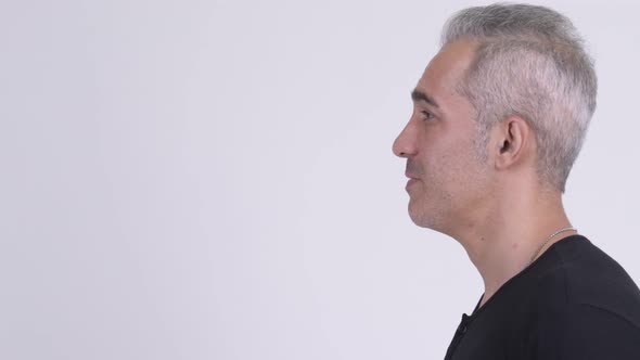 Profile View of Handsome Persian Man Talking Against White Background