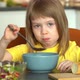 Little Girl Eats with Spoon Tomato Soup Puree with Croutons and Cheese on Kitchen - VideoHive Item for Sale