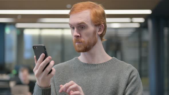Portrait of Young Man Celebrating on Smartphone