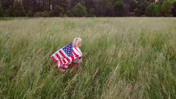 American Woman Proudly Holding American Flag at Sunset Field Celebrate 4Th of July