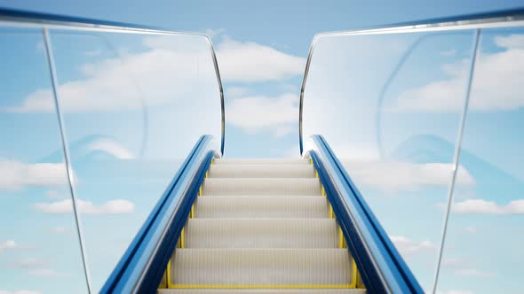 Modern escalator made of glass and steel. Blue sky with clouds in the background