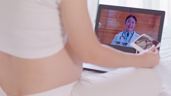 Pregnant woman video call conference online to meeting and consult with doctor at home
