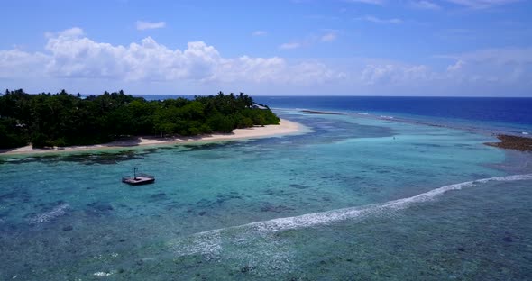 Wide angle above island view of a white sand paradise beach and aqua blue ocean background in best q