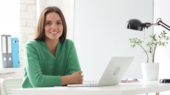 Creative Woman Looking at Camera  in Office