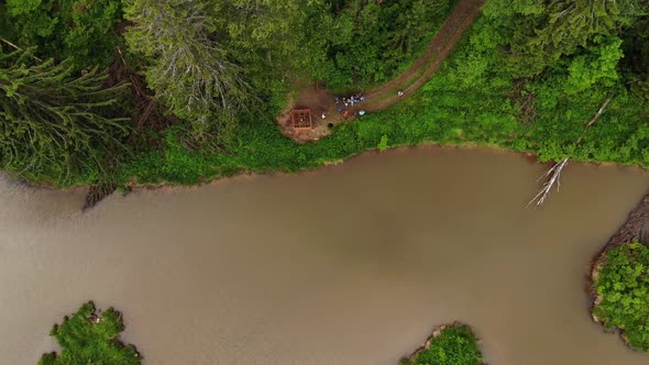 Aerial View Group of Tourists with Guided Walking Near River at Forest