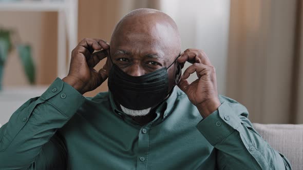 Portrait of Smiling Mature Elderly Man Looking at Camera African American Grandfather Sitting in